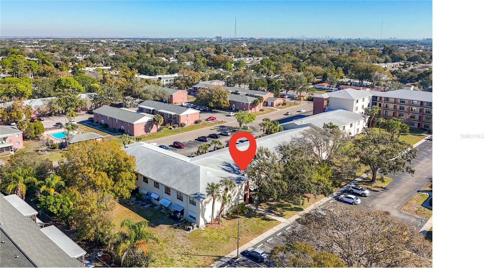 1020 85th Ave N no 119 view from back of condo showing visitor parking and patio garden side of unit