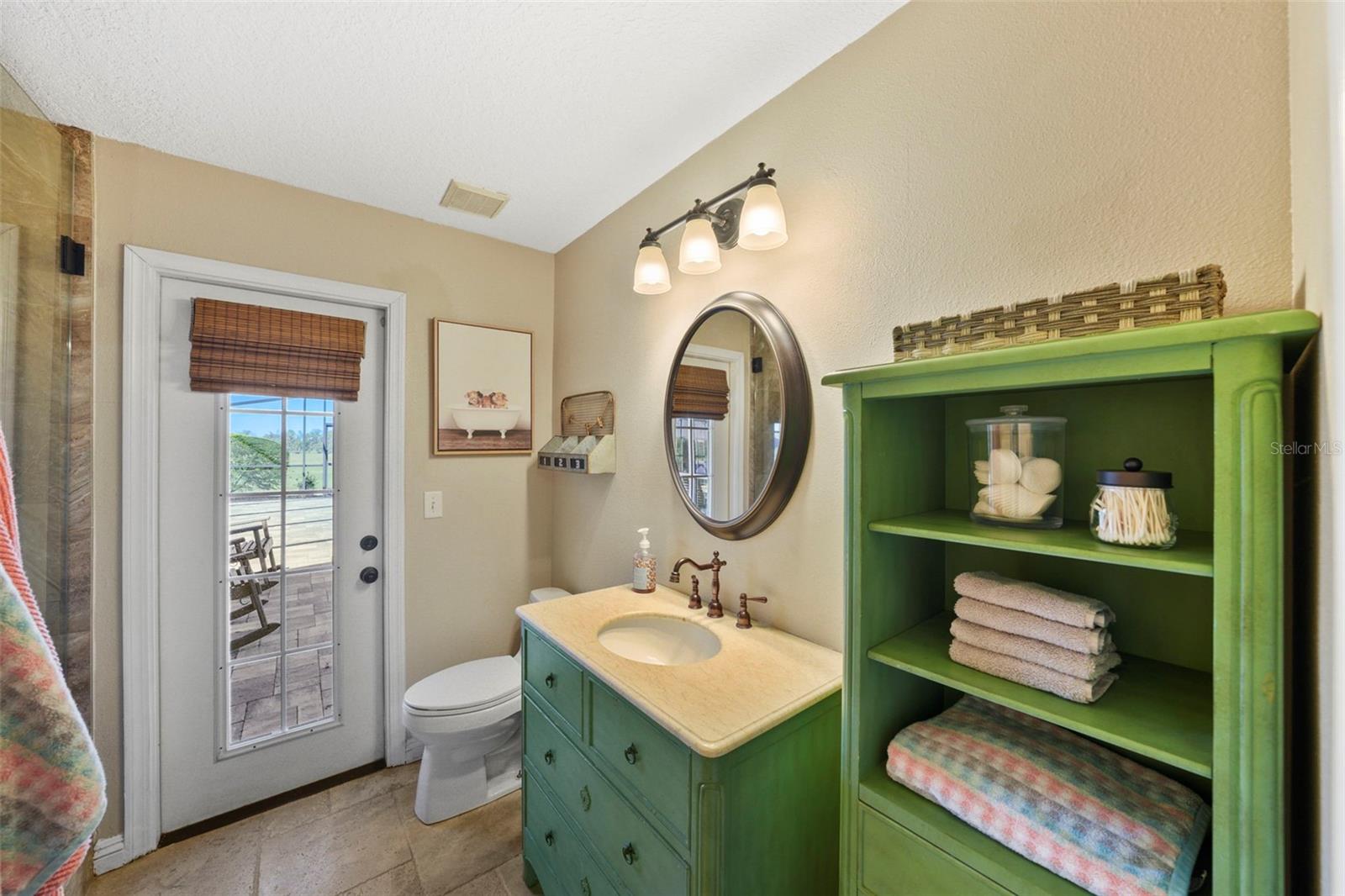 Full bath by mudroom with pool access
