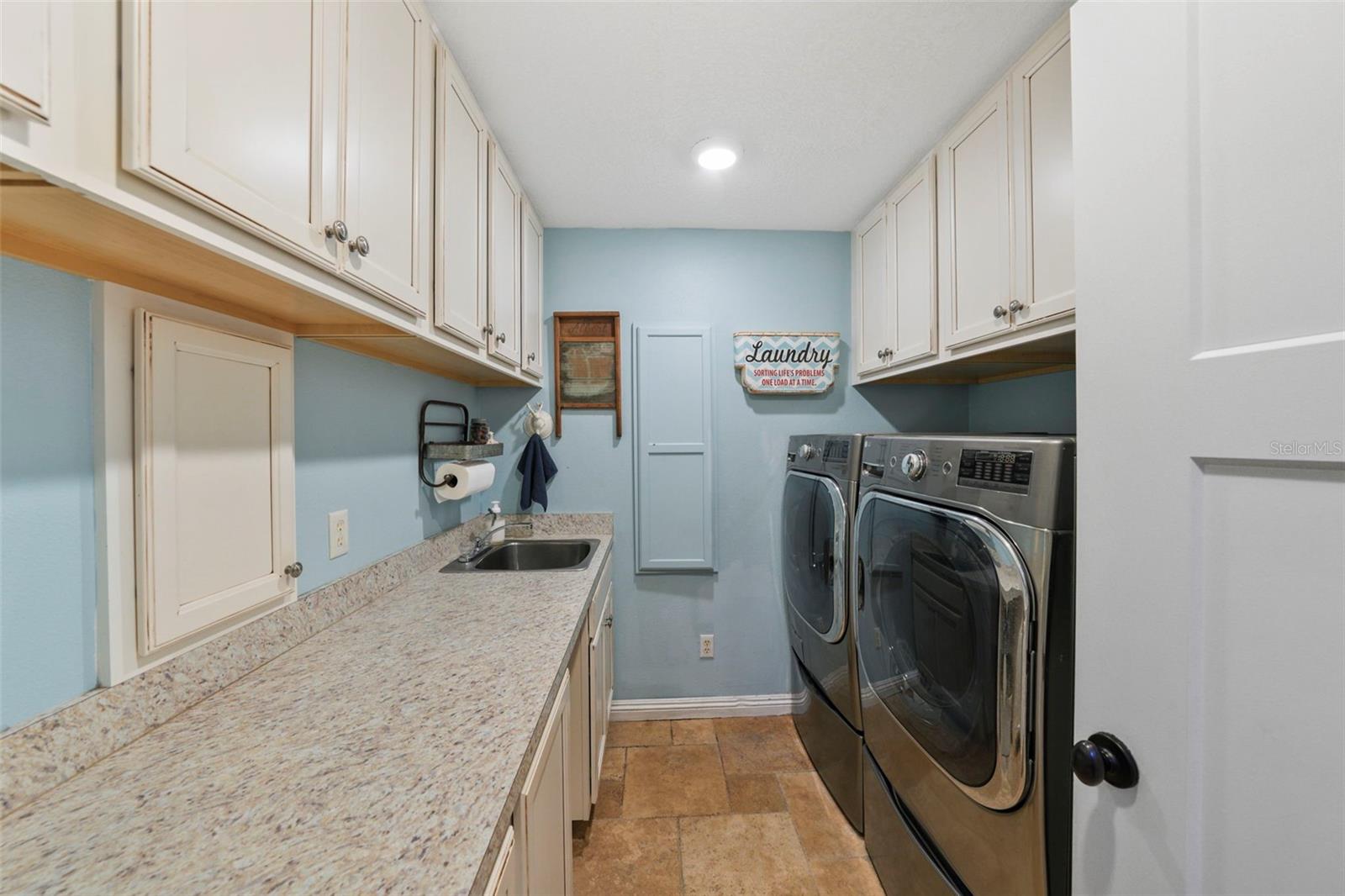 Full Size Laundry room with Cabinets and laundry cute from primary bedroom