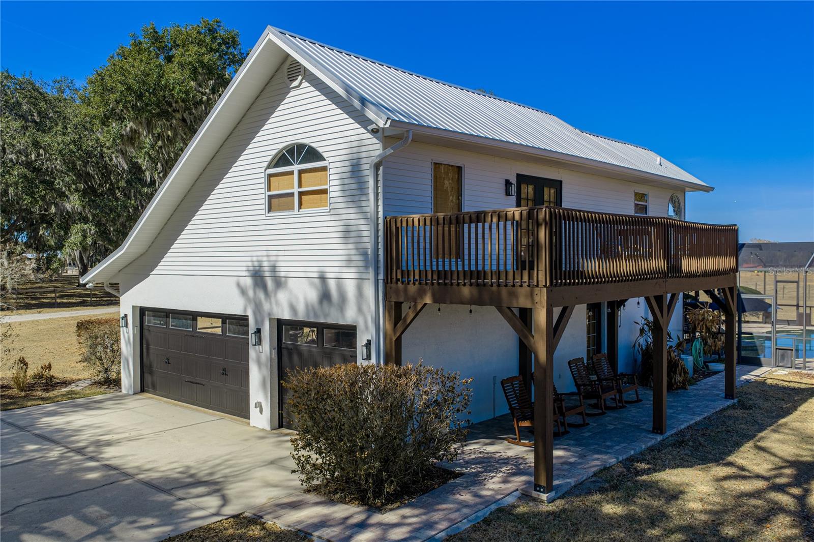 Paved driveway, outdoor back porch for relaxing,Upstairs primary bedroom balcony.