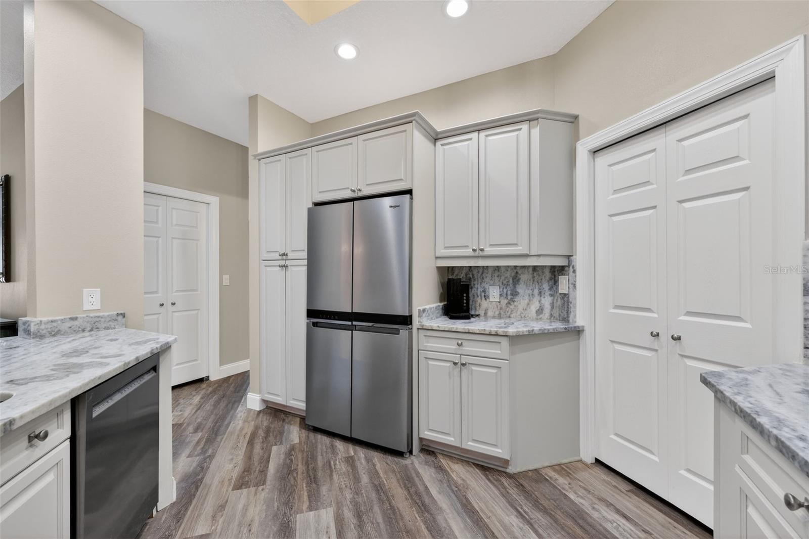 The kitchen has granite counters, Stainless appliances and lots of storage