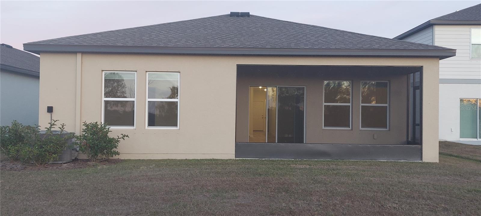 Covered screened in lanai from back yard