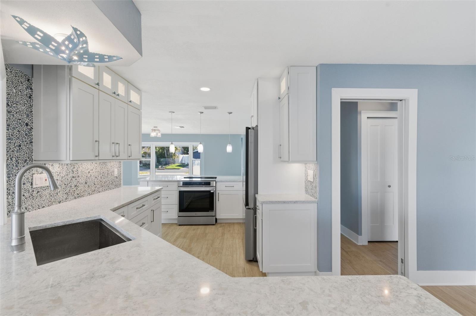 Looking into the kitchen from the small den with fireplace