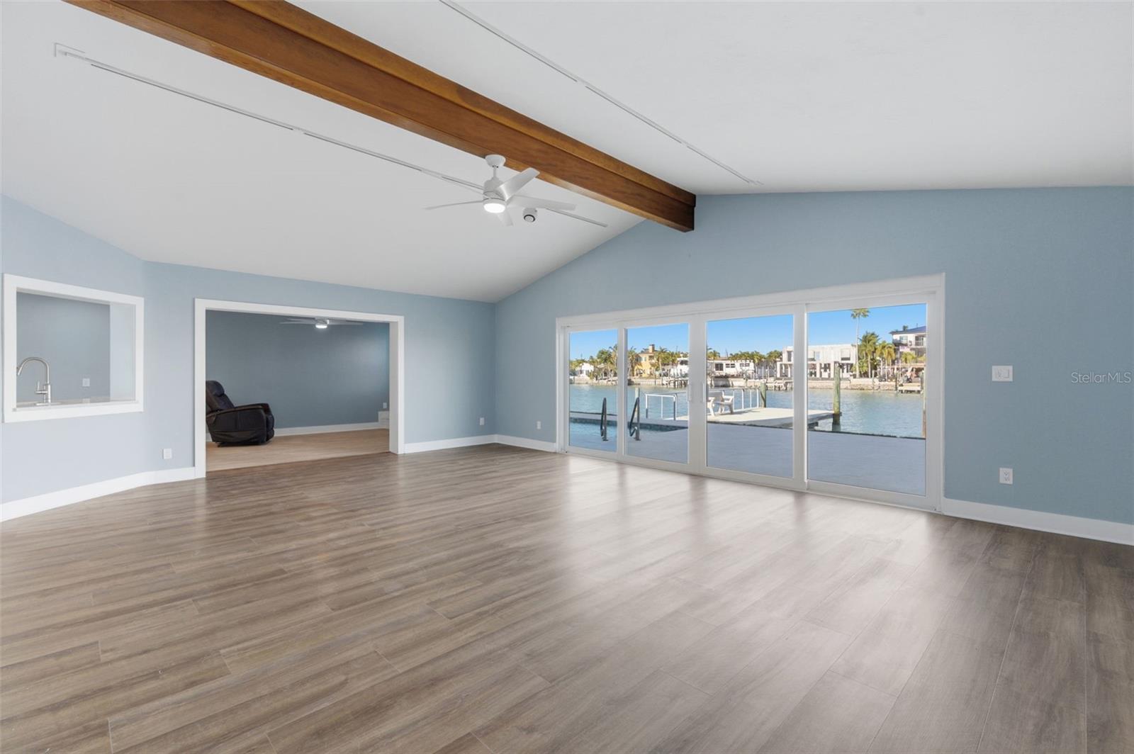 The great room with a beautiful view of the pool and canal