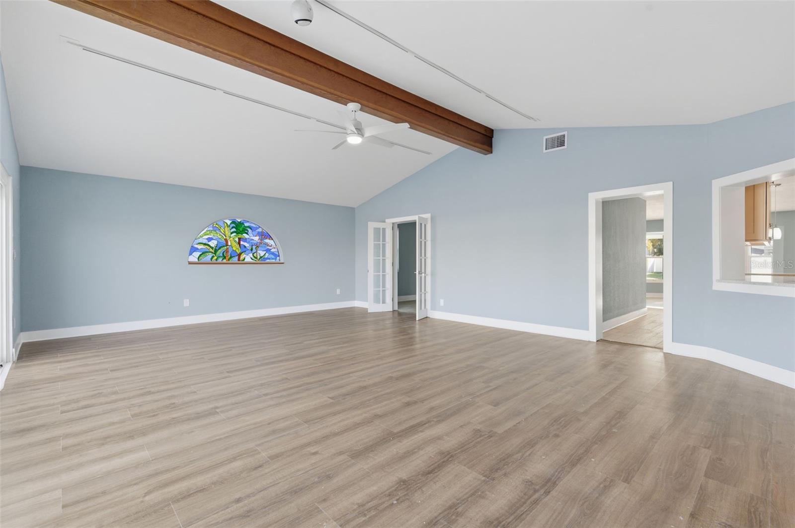 Great room with French doors to the primary bedroom
