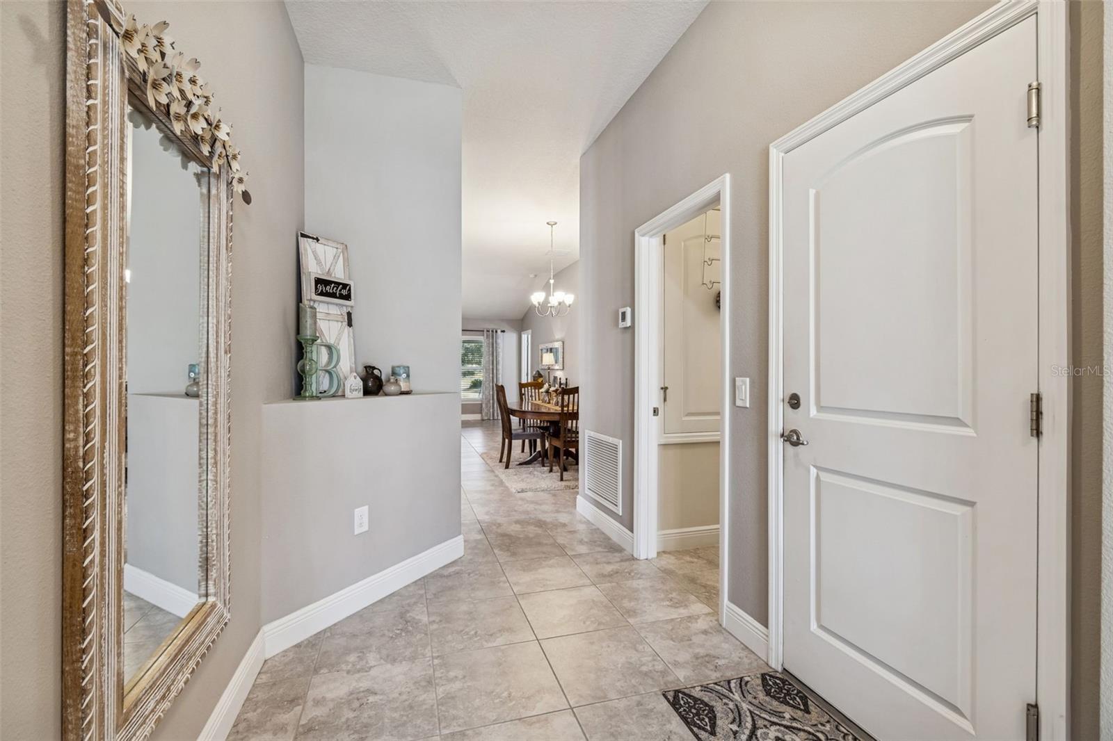 From front door entry, 1st door to the Right leads to the garage.  2nd door to the Right leads to the Laundry Room.