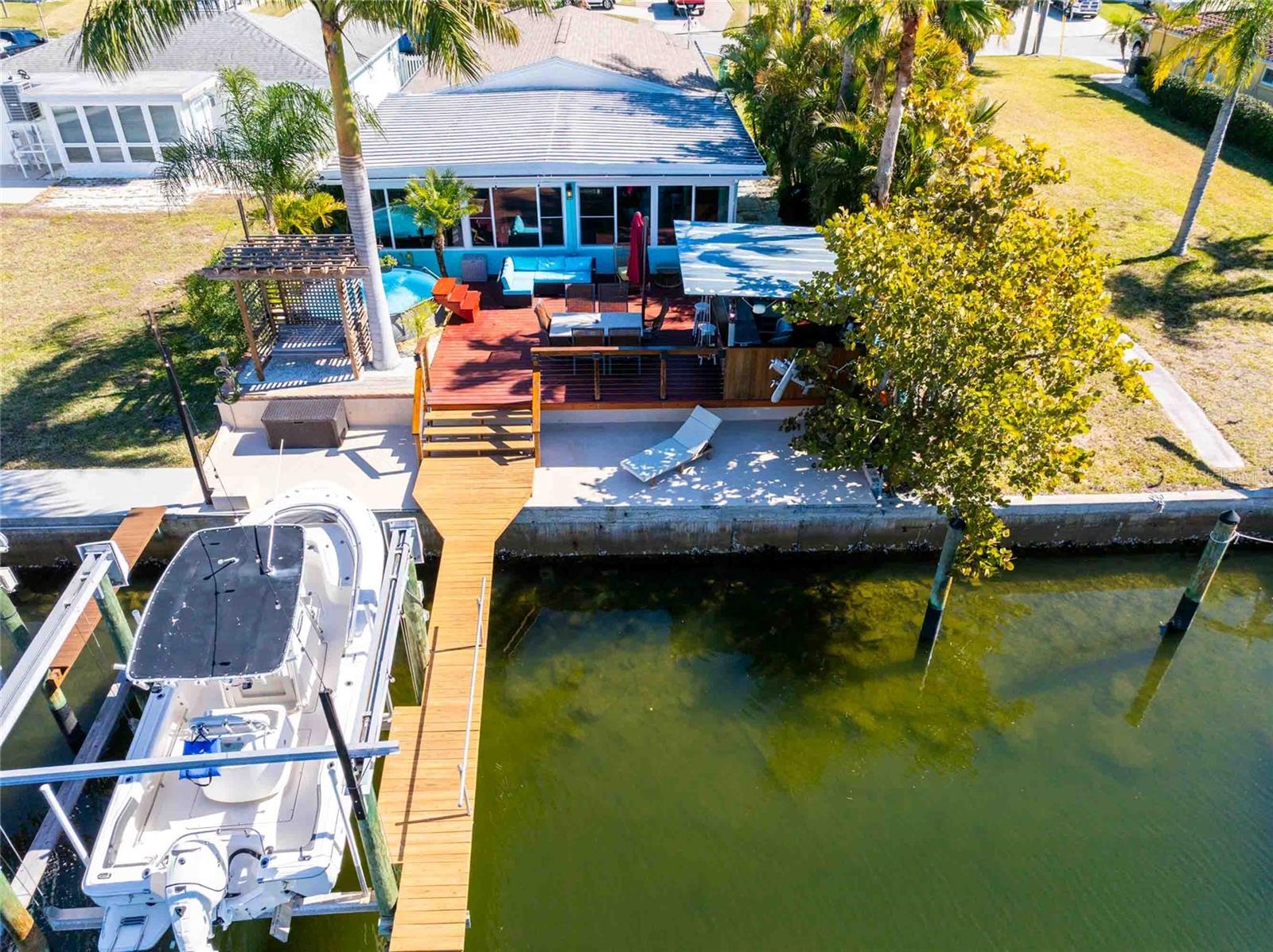 Your private oasis has a Tiki Bar, dining area, pool, and pergola with a swing.