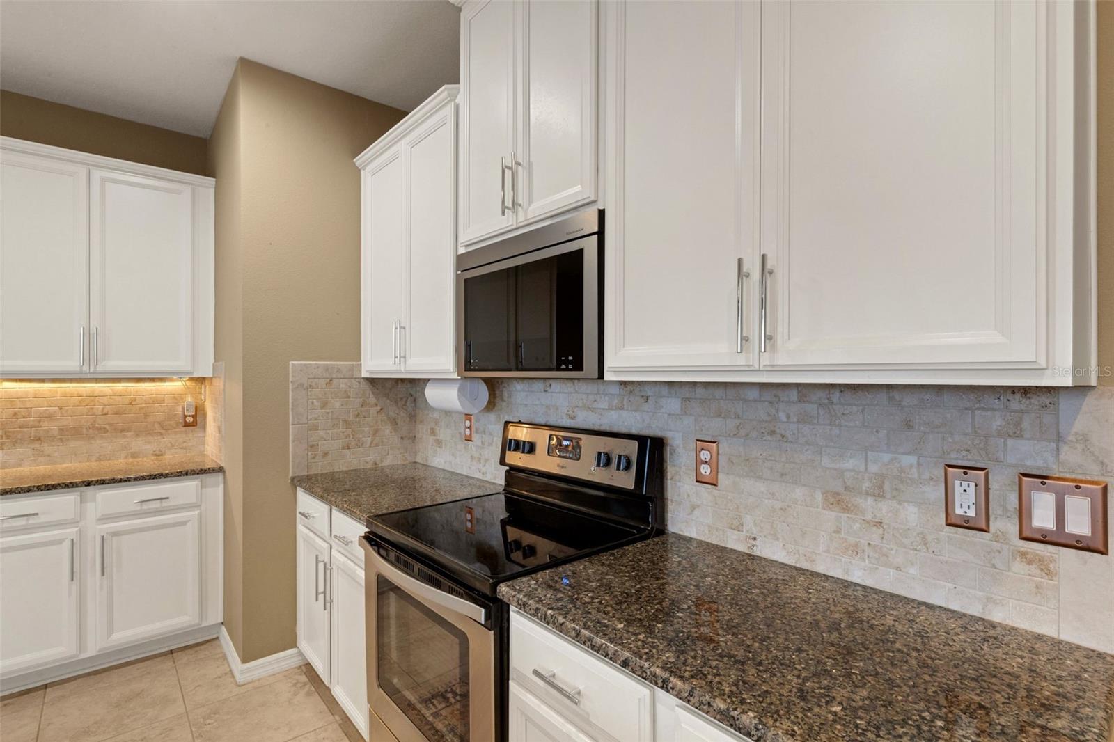 Spacious open kitchen with views of back oasis and pond.