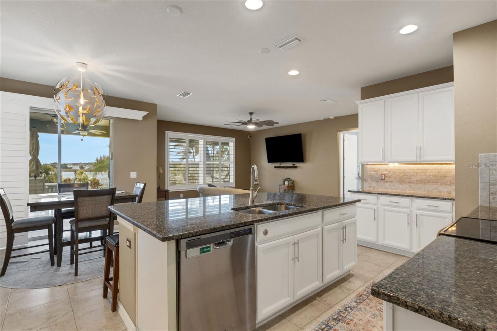 Spacious open kitchen with views of back oasis and pond.