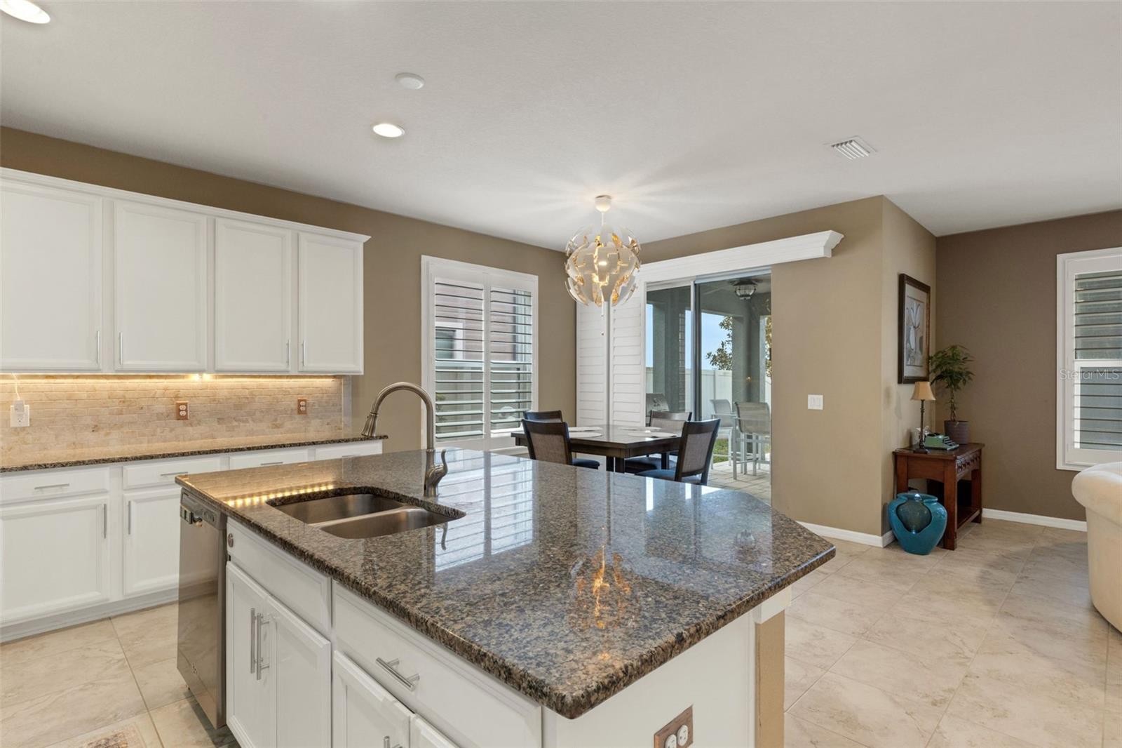 Spacious open kitchen with views of back oasis and pond.