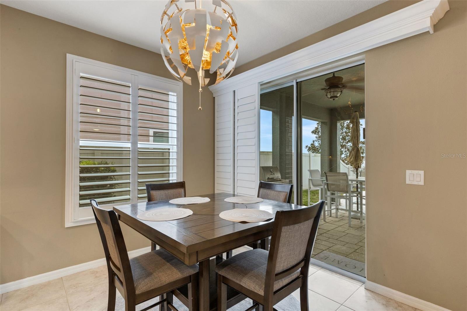Dining with a view of backyard oasis and pond.