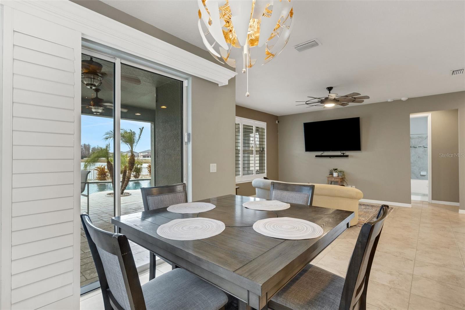 Dining with a view of backyard oasis and pond.