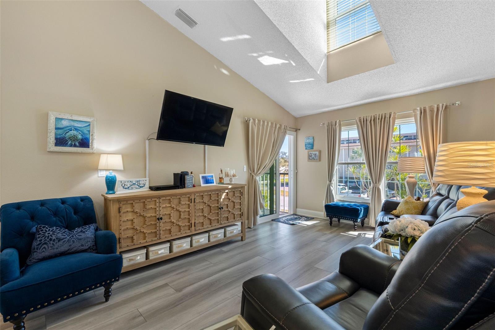 Sliders open to screened porch.