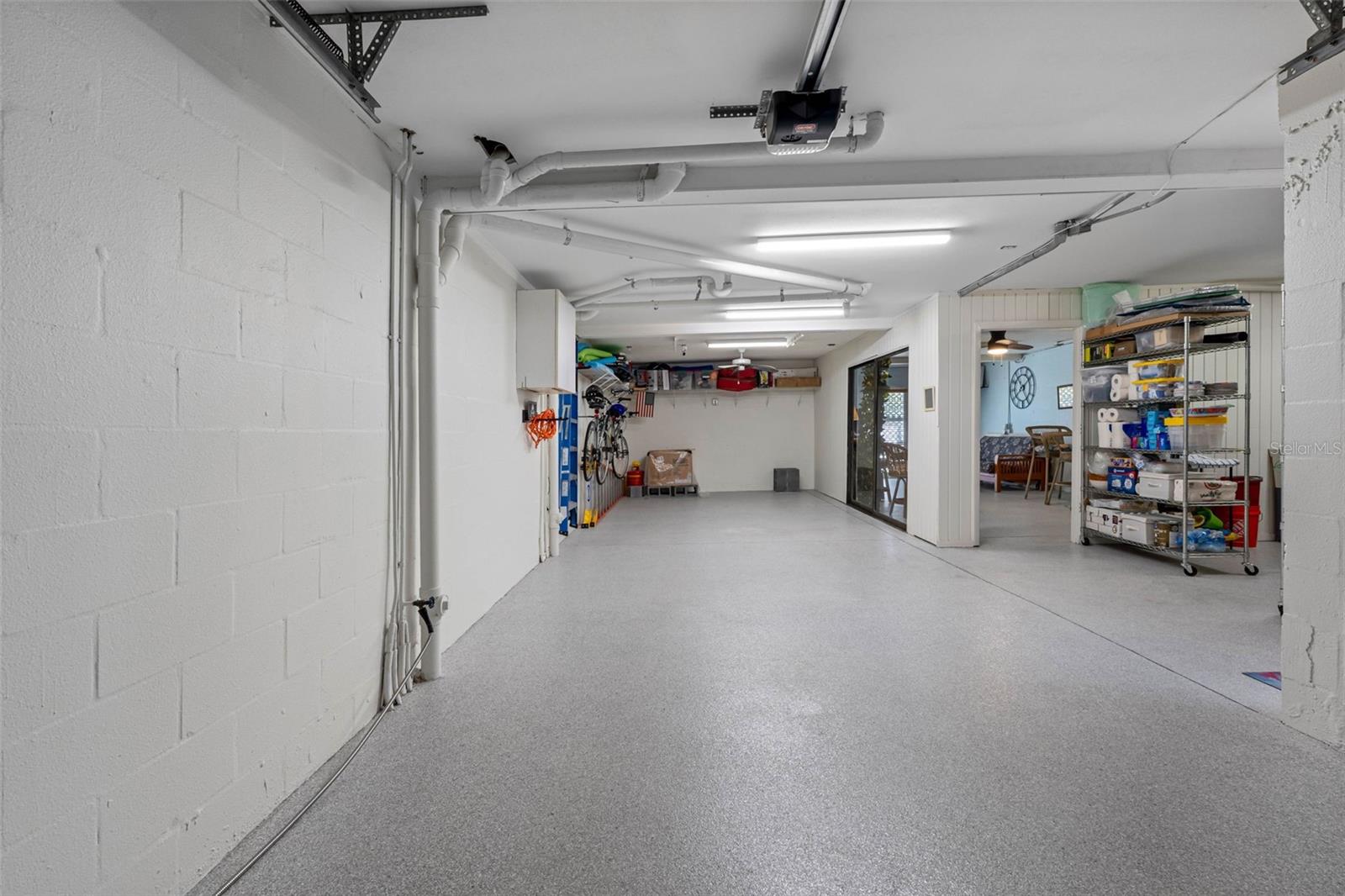 Tandem parking for two vehicles with epoxy floor covering.