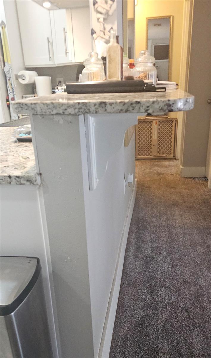 Extended granite ledge for extra seating at each side of the kitchen.