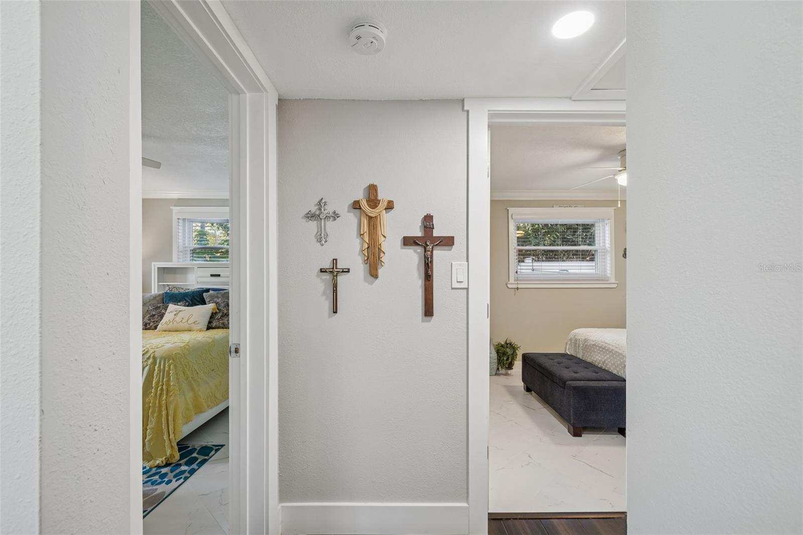 Hallway just off the front door with 2 guest bedrooms and second full bathroom