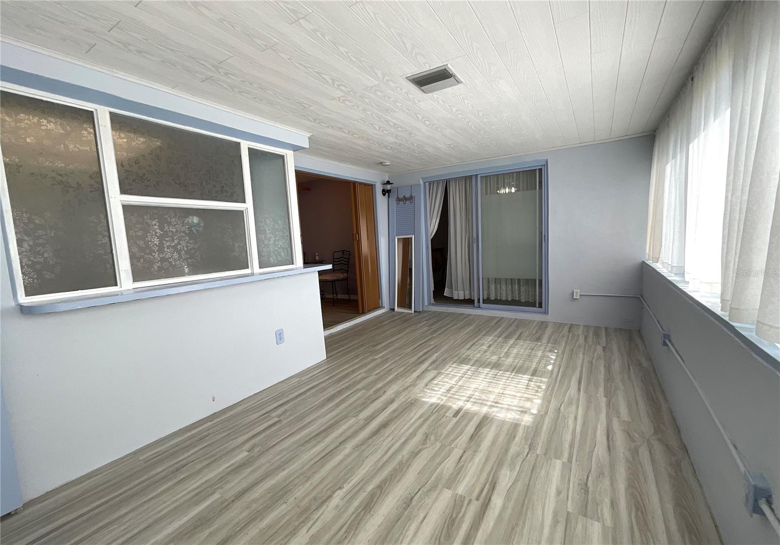 14-Family room view from other end shows slider to primary bedroom