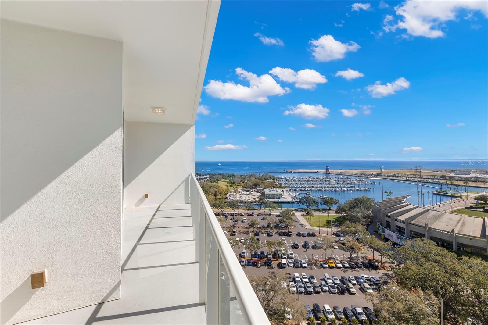 Living room with direct access to a private balcony capturing panoramic water and city views