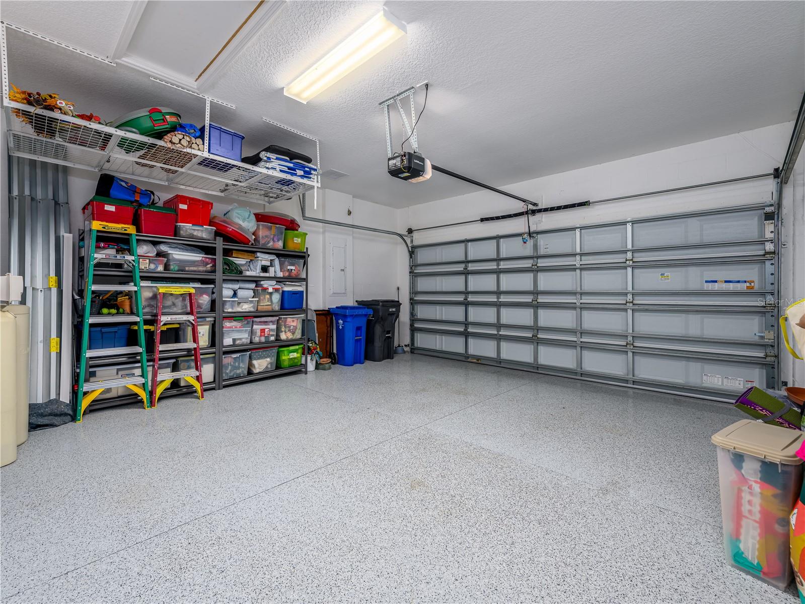 Garage with epoxy flooring and ample storage