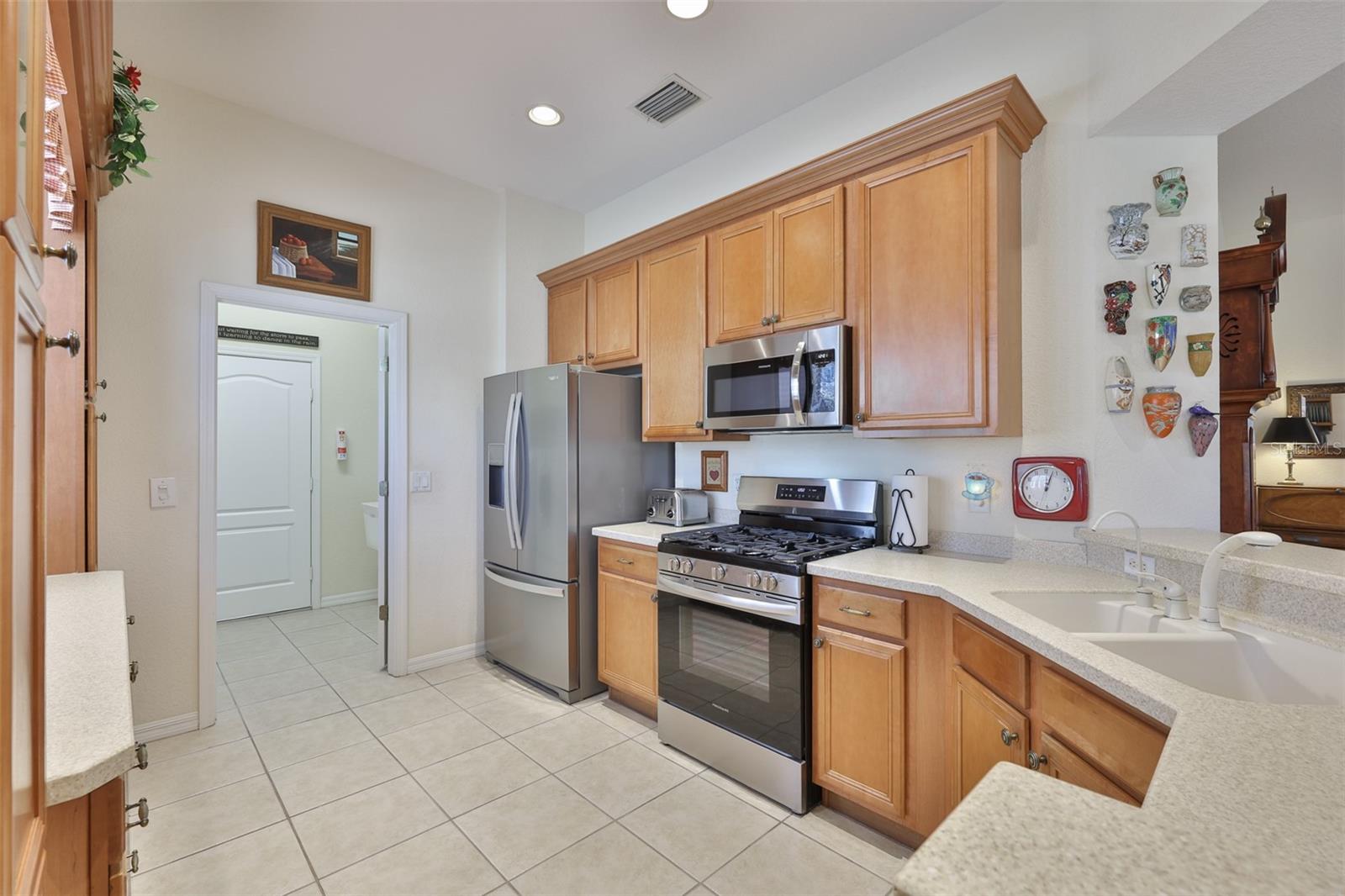 Sparkling clean and bright, this kitchen is well appointed with stainless steel appliances including a gas range.