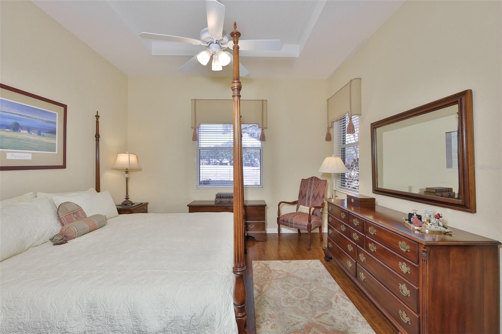 Multiple windows allow Florida sunshine to filter into the room, with views of the golf course and water.