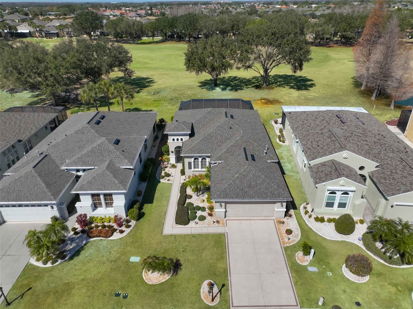 Manicured lot faces the golf course (5th hole) with a water view to the far right.