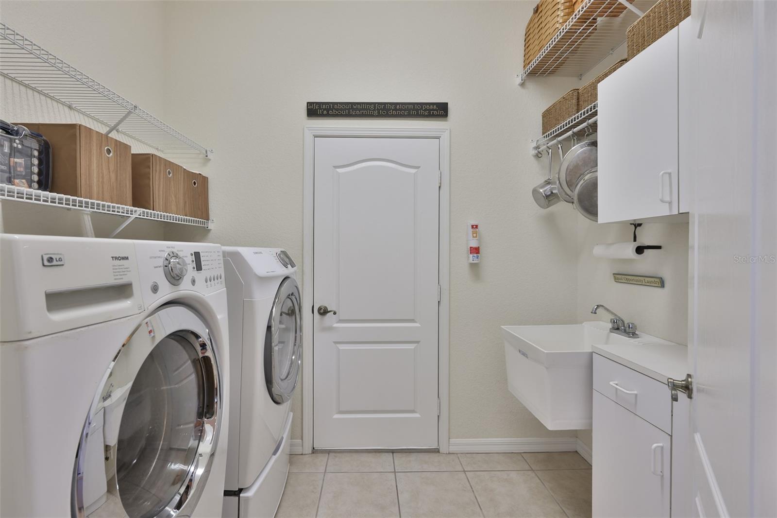 Laundry room is sparkling clean, very well lit with newer appliance, storage and utility sink. This room leads to the two car garage.
