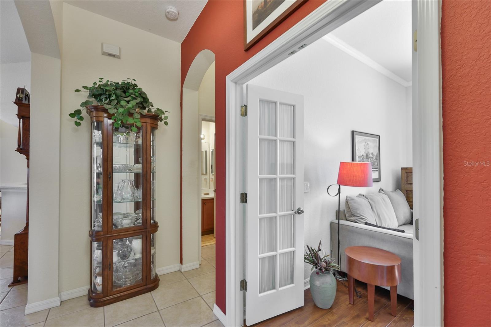 As you walk into the home, you will pass the den/office/third bedroom, and then the guest bathroom and bedroom.