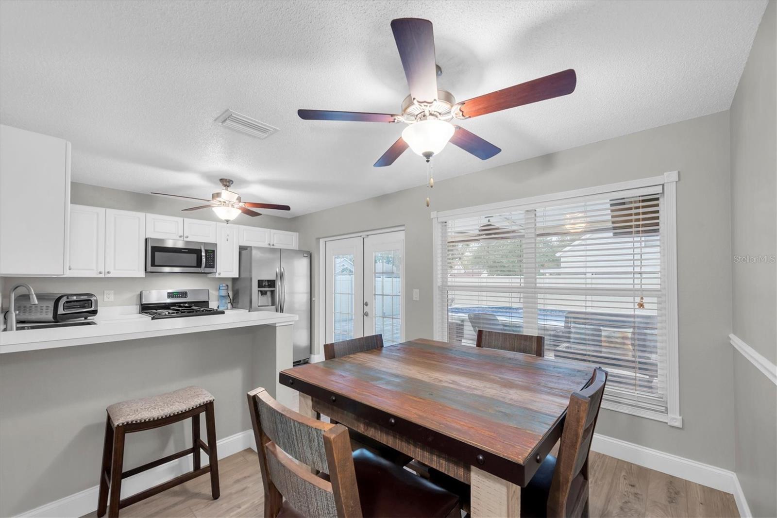 The dining area over looks the pool in the backyard.