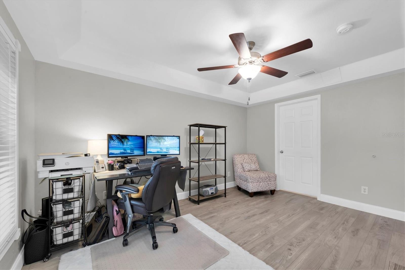 The primary bedroom is currently being used as a home office.