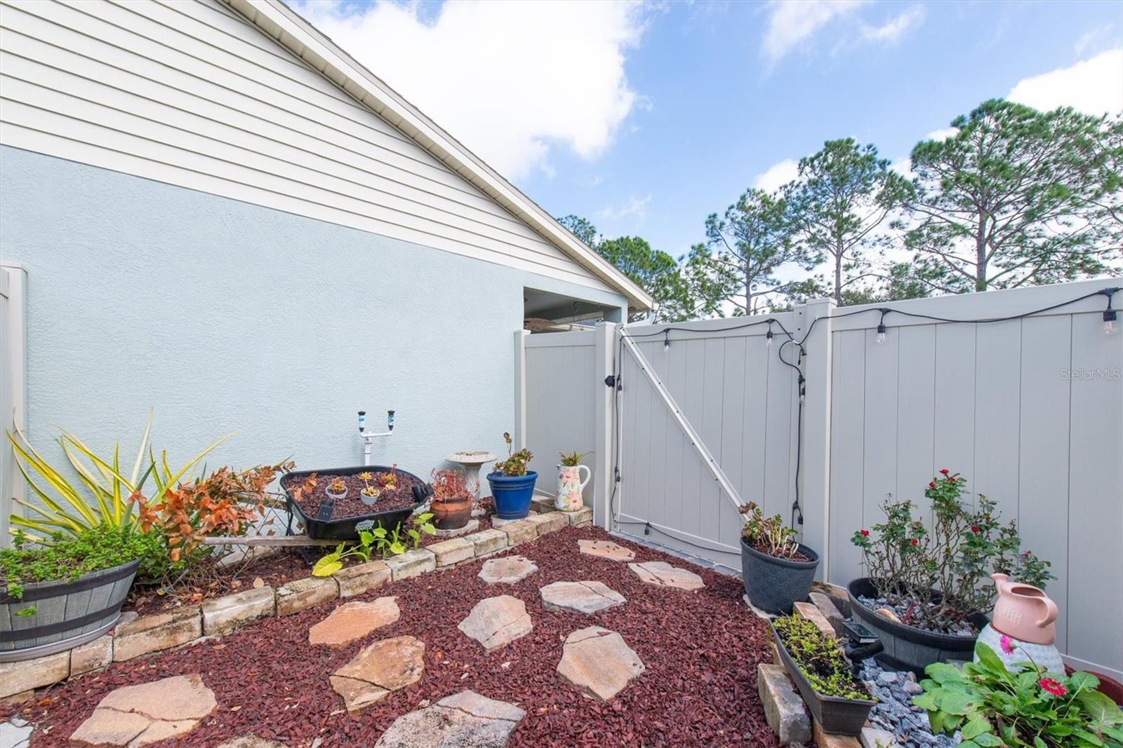 On the side of the yard is a completely fenced secret garden