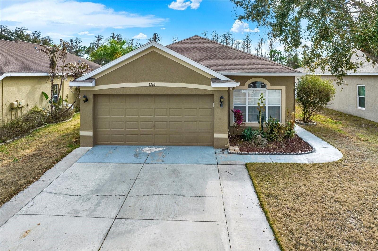 Front exterior of 12631 Chenwood Ave in gated community