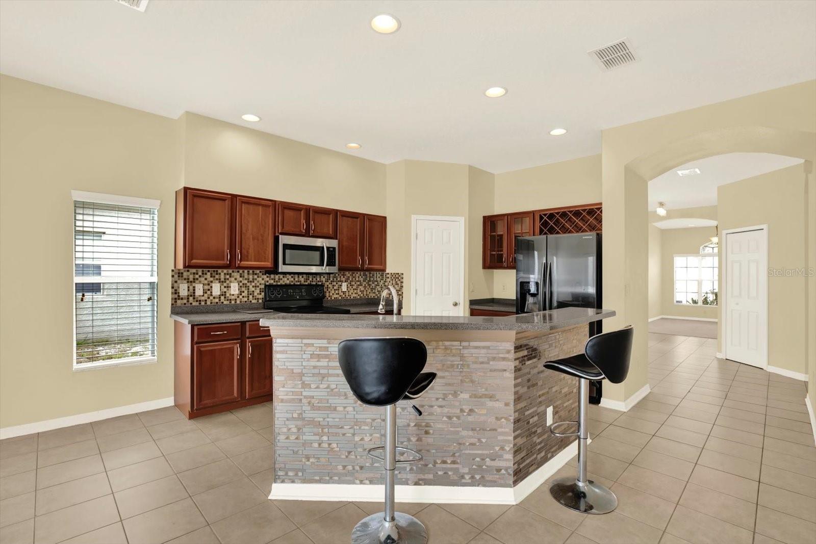 Kitchen with breakfast bar and wood cabinetry