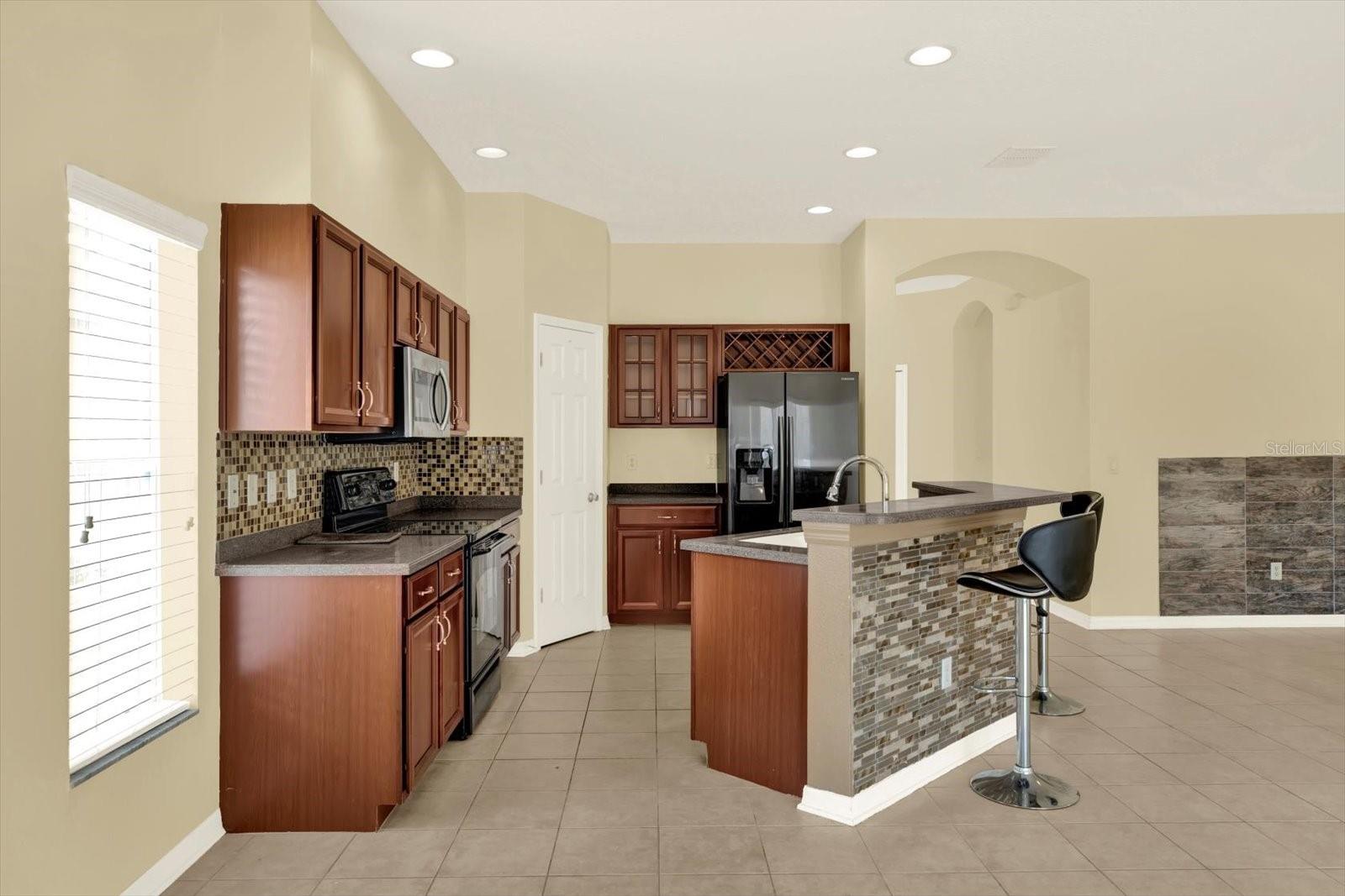 Kitchen with breakfast bar and wood cabinetry