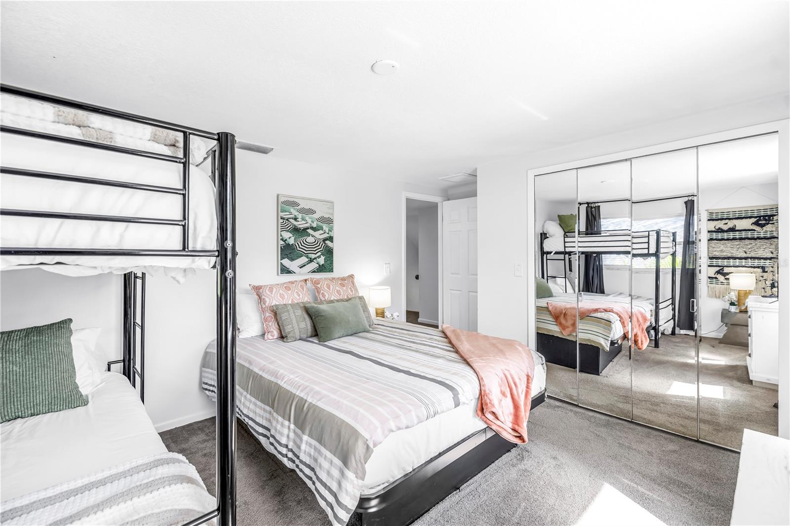 Queen size bed and bunk beds fit comfortably in the space