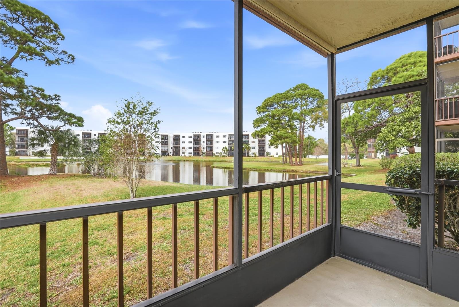 Serene pond and fountain views with wide-open green space.