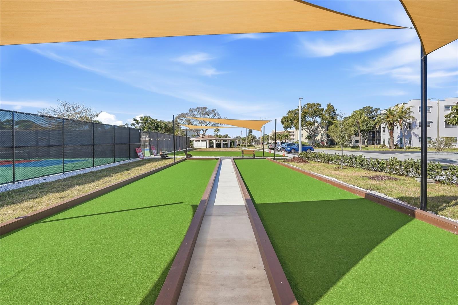 Bocci courts with shade sails—perfect for friendly competition.