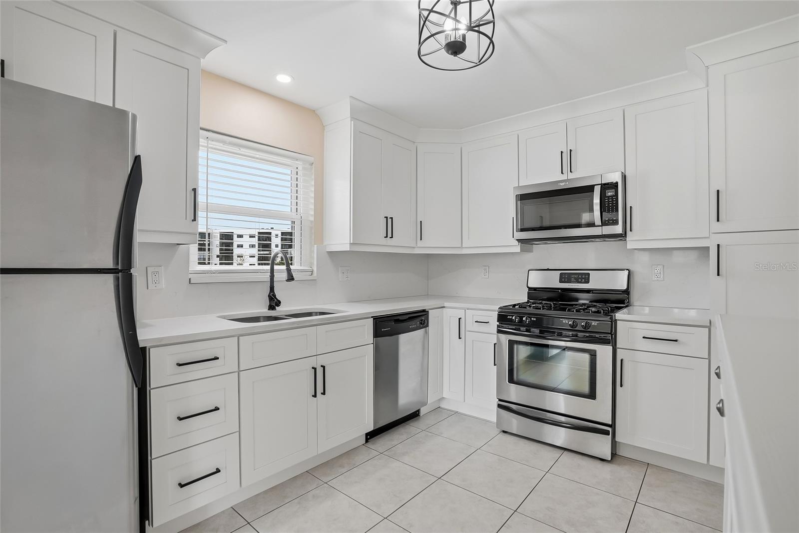 Spacious kitchen with stainless appliances and abundant storage throughout.