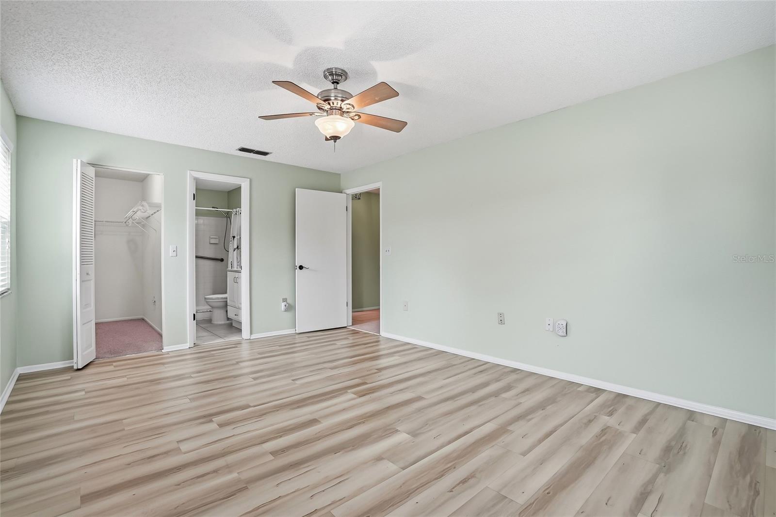 Spacious primary bedroom with plenty of wall space for your preferred layout.