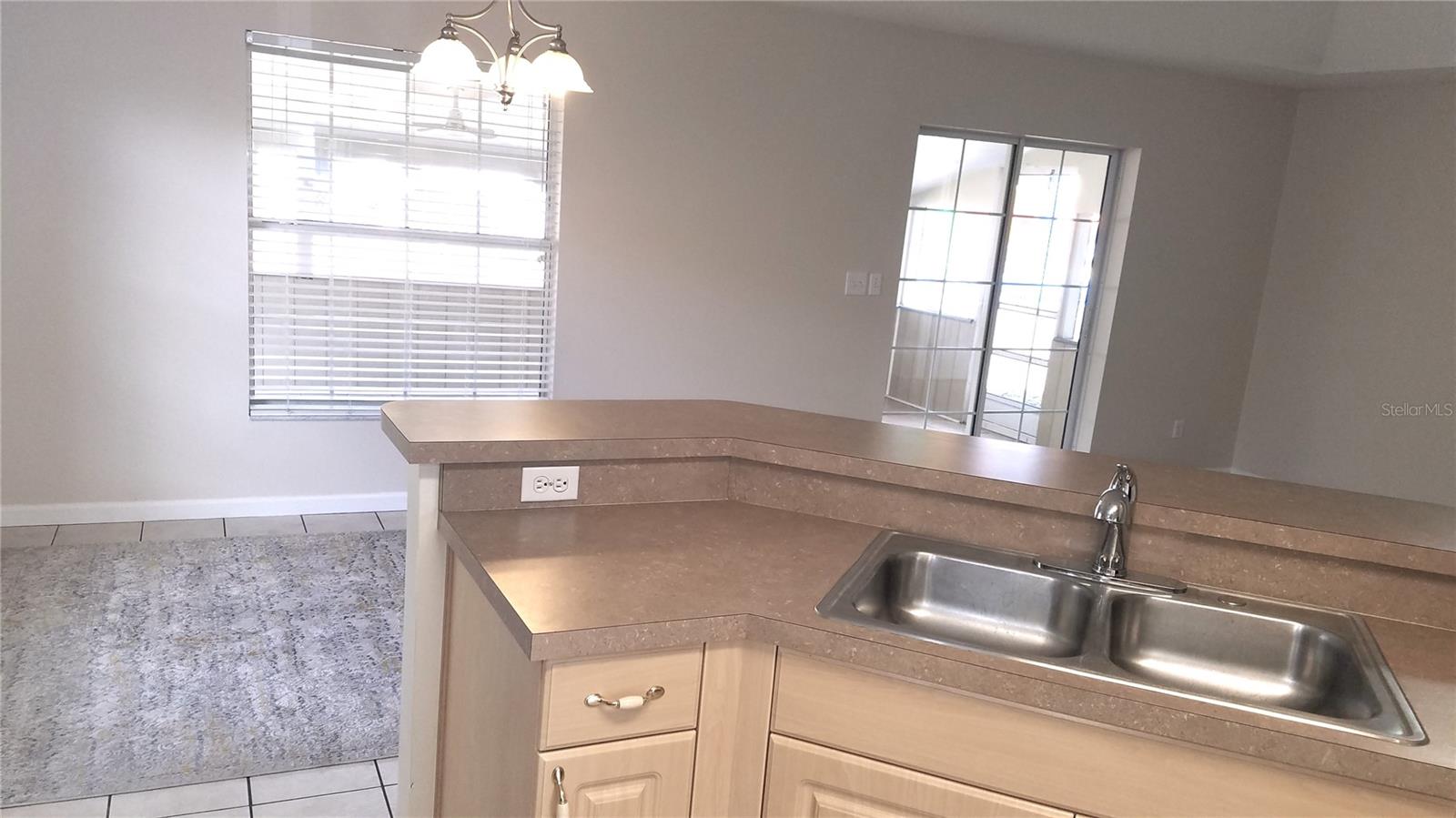 View from kitchen to porch & back yard