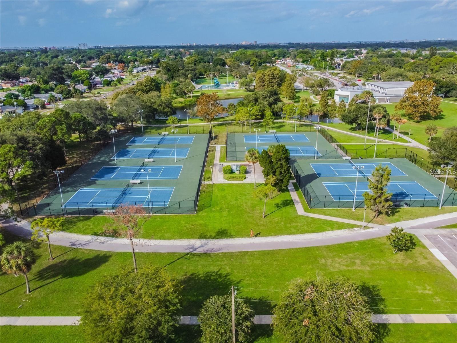 Beautiful tennis, basketbal, and pickleball courts in park right a cross the street.
