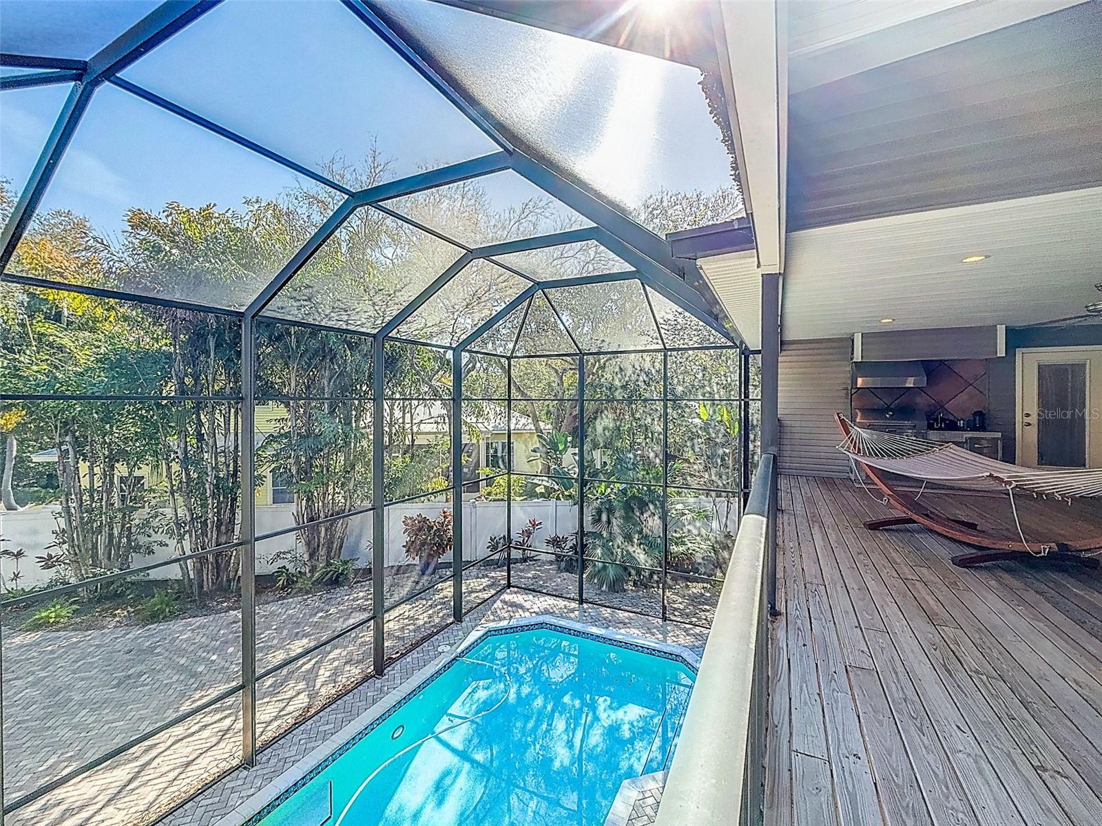 Balcony with outdoor kitchen overlooking the pool