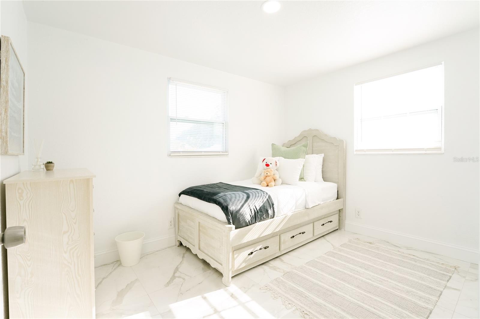 Light and airy guest bedroom ideal for visitors, family members, or rental guests.