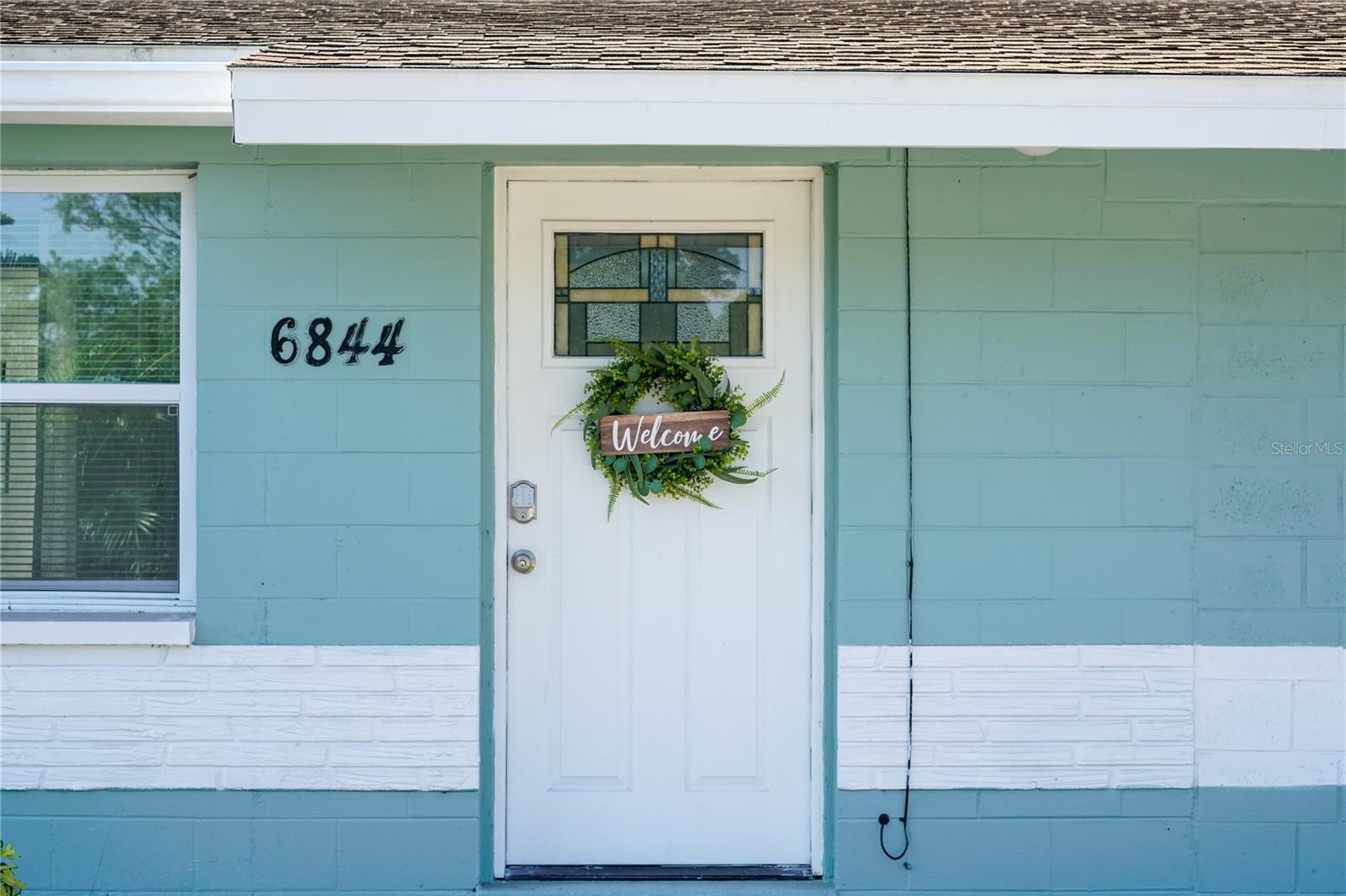 Welcoming front entrance with charming curb appeal, setting the tone for the warmth and comfort found throughout the home.