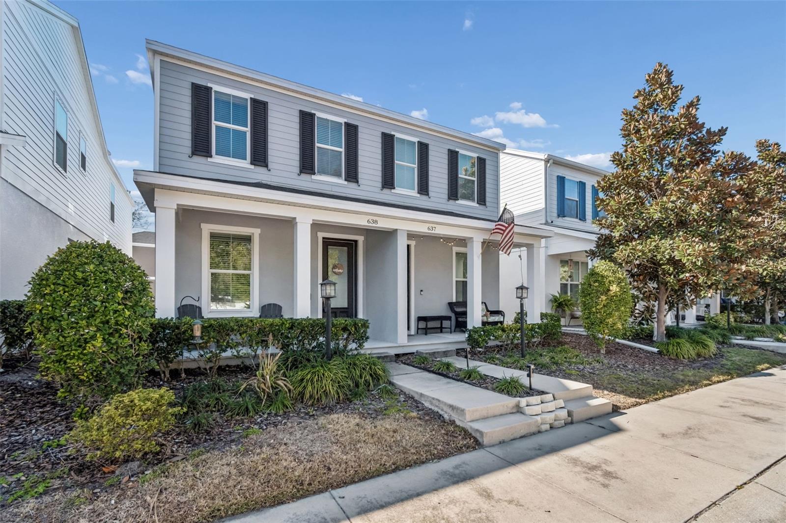 Clean, traditional façade with symmetrical windows and covered front porch, ideal for enjoying morning coffee or evening conversations.