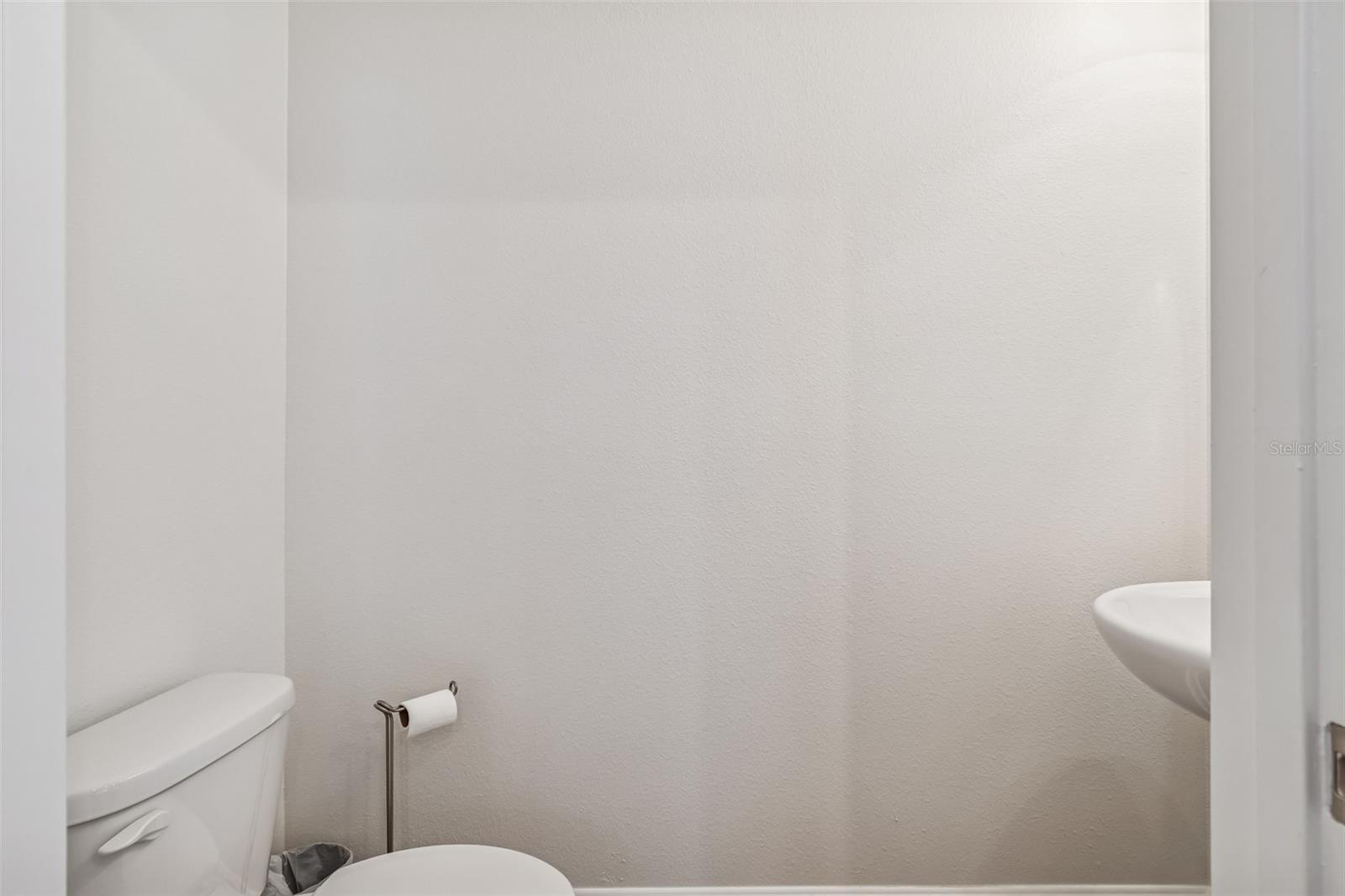 Conveniently located half bath with sleek fixtures and practical layout.