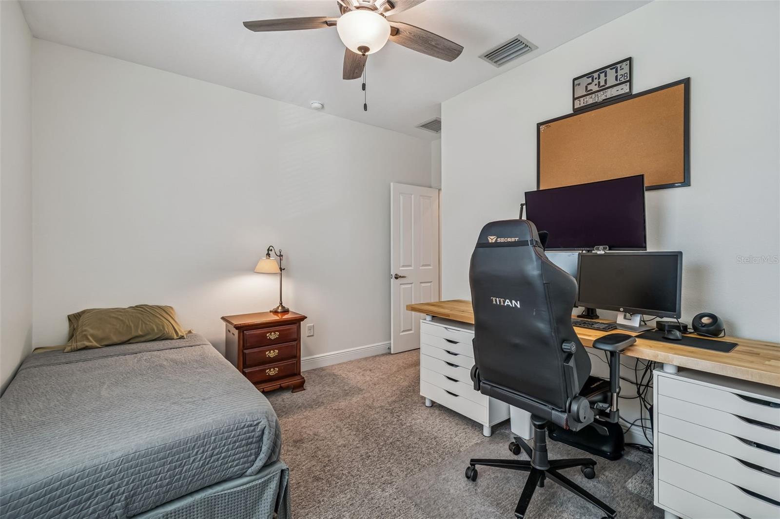 Spacious upstairs hallway with recessed lighting, wood-look flooring, and easy access to bedrooms and bath.