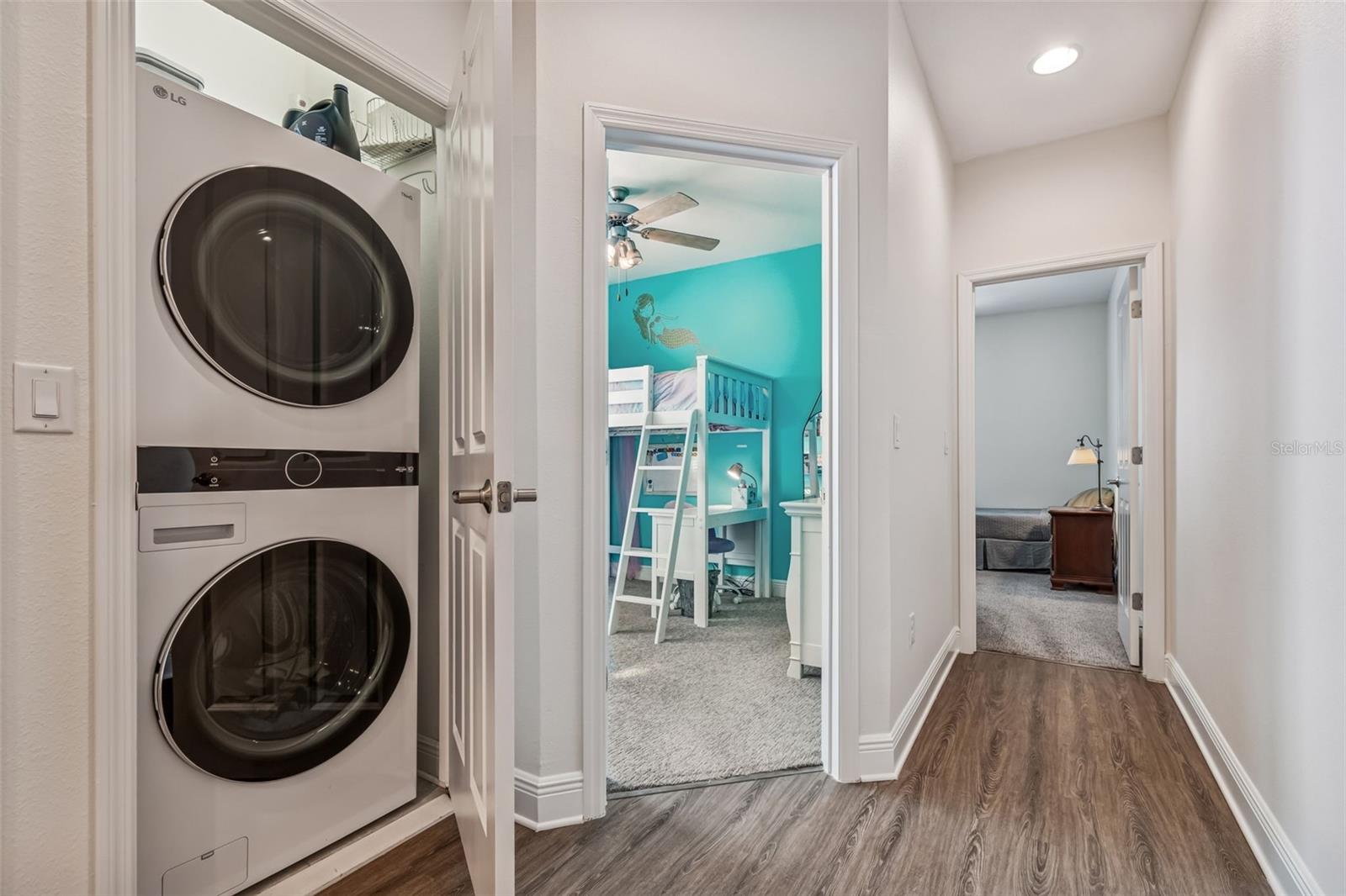 Central laundry nook ideally positioned between secondary bedrooms for efficient routines.