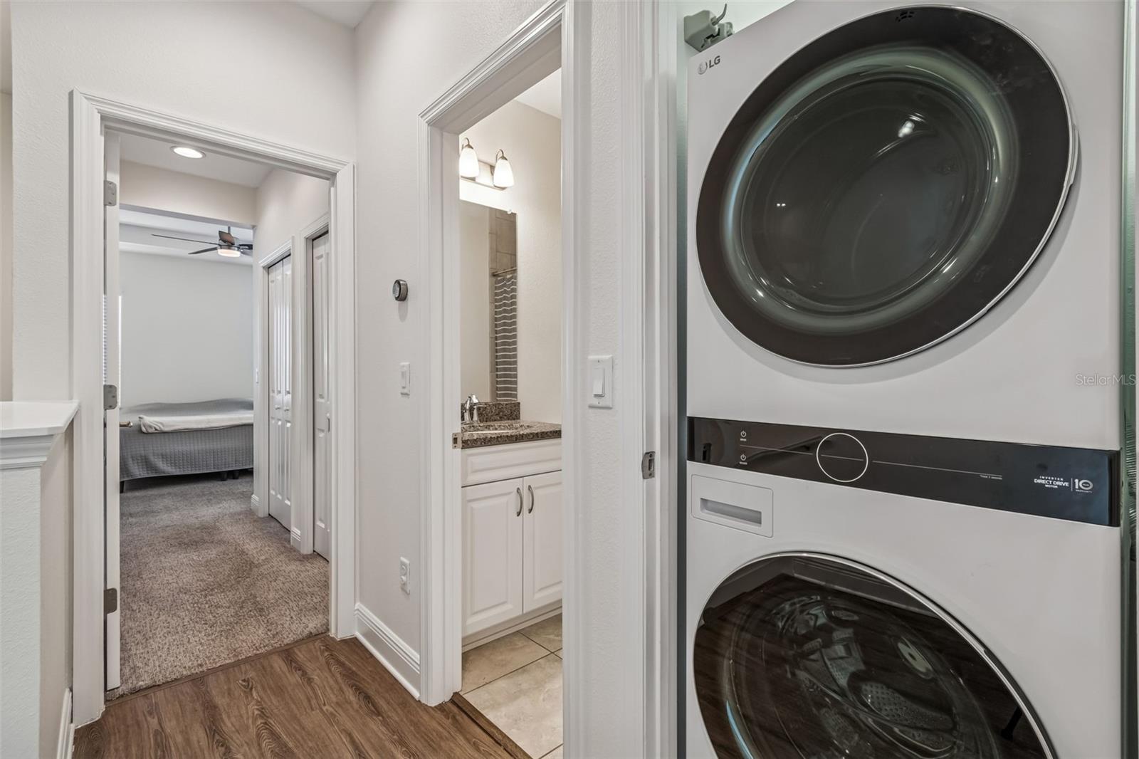 Located near all bedrooms, the stacked laundry system keeps functionality central and discreet.