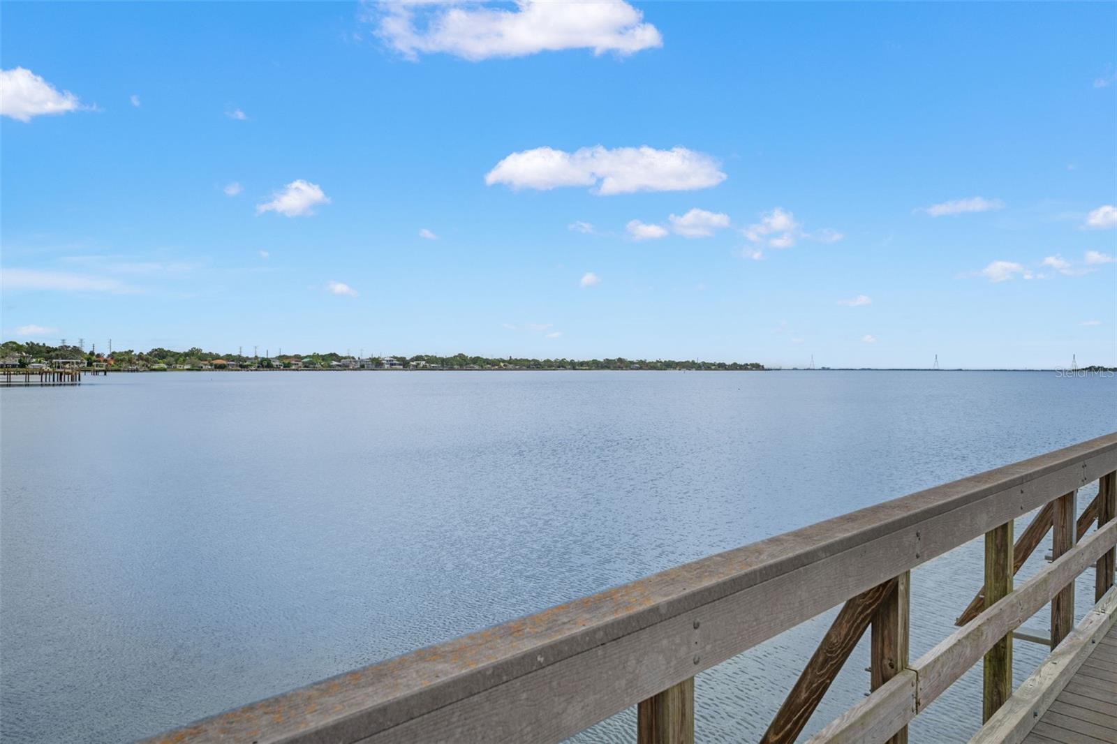 Looking east across the bay with distant homes and the bridge in view—capturing the area's quiet charm and coastal appeal.